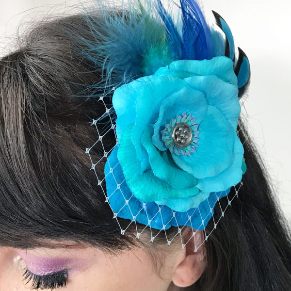 Close up of Turquoise Blue Rose Fascinator on hair