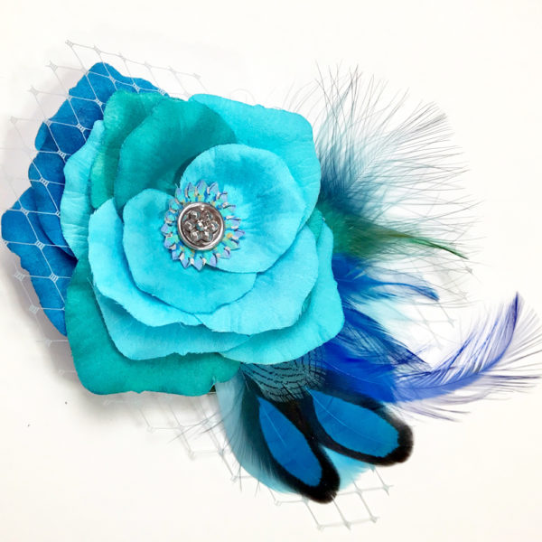Close up of Turquoise Blue Rose Fascinator on white background