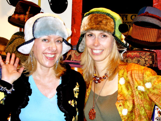 2 women wearing the Pom Pom design hat
