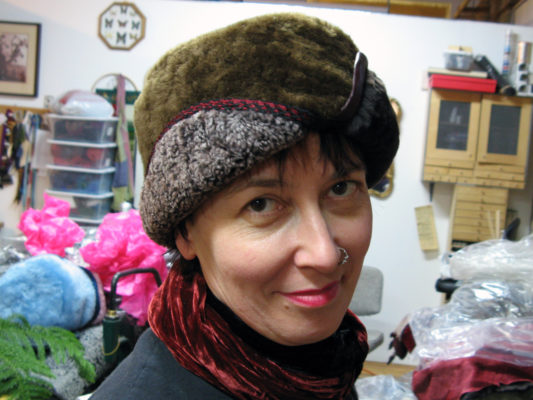 A woman wearing a Snowflake shearling brown hat in the studio