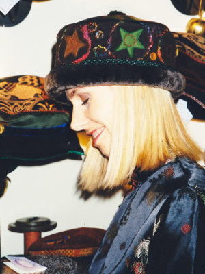 A close up of a woman wearing a brown Rusalka hat with appliqué felt stars on it.