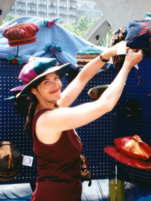 Gwendolyne placing a hat in her display booth at the TOAE