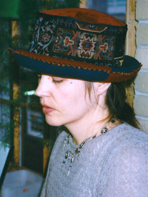 Close up of Gwendolyne wearing a tapestry Uptown rim hat.