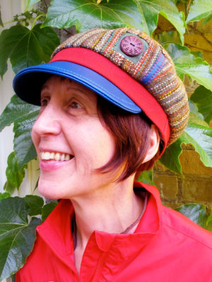 A close up of customer wearing her new royal blue, green and red Abbey Road Cap