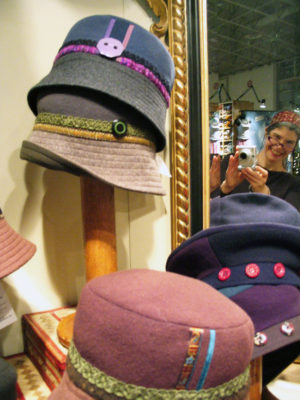 Several Caprice Design hats on display in the shop