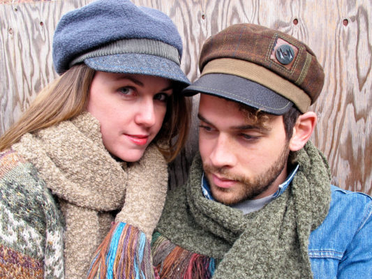A close up of a man and woman wearing the Donavan and Abbey Road Caps