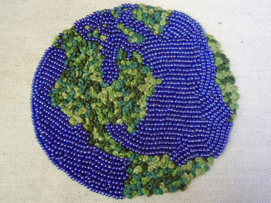 Artwork of the world created in beadwork and french knots