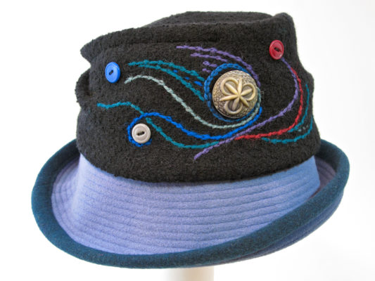 A Harvest Moon hat in black with a light blue upper rim.