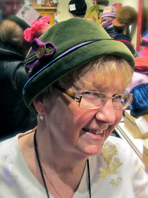 Close up of a happy new customer wearing her new olive LaBijou hat.