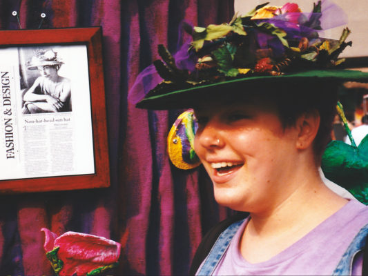Close up a a woman smiling and wearing the Open Silk Rim Hat.