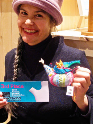 woman smiling with teapot pincushion