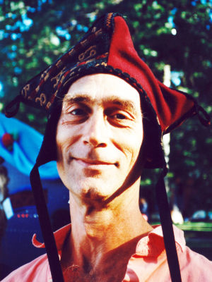 Close up of man smiling wearing a red Four Corner Hat.