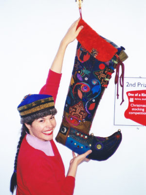 Woman holding up 3' christmas stocking