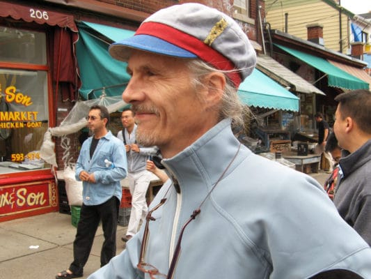 Close up of man wearing a Gwendolyne linen cap in Kensington Market