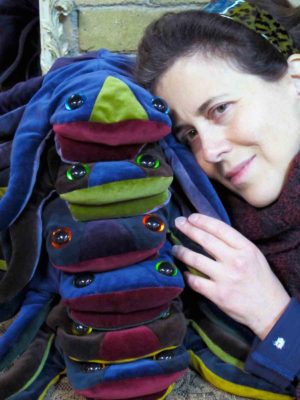 A happy client hugging her 5 stacked velvet frogs made by Gwendolyne