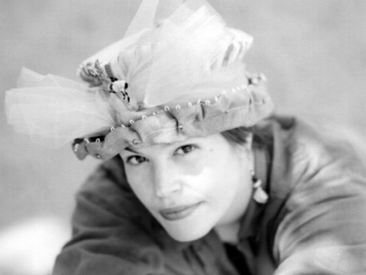 Close up of Gwendolyne Preboy modelling a bee in the bonnet silk hat