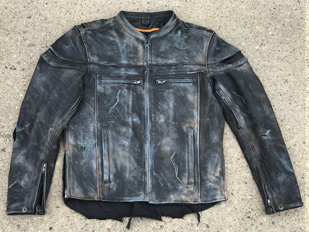 Extreme wear and tear on front of black leather jacket